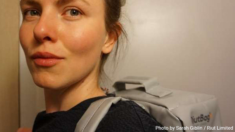 Woman wearing a Riut backpack.