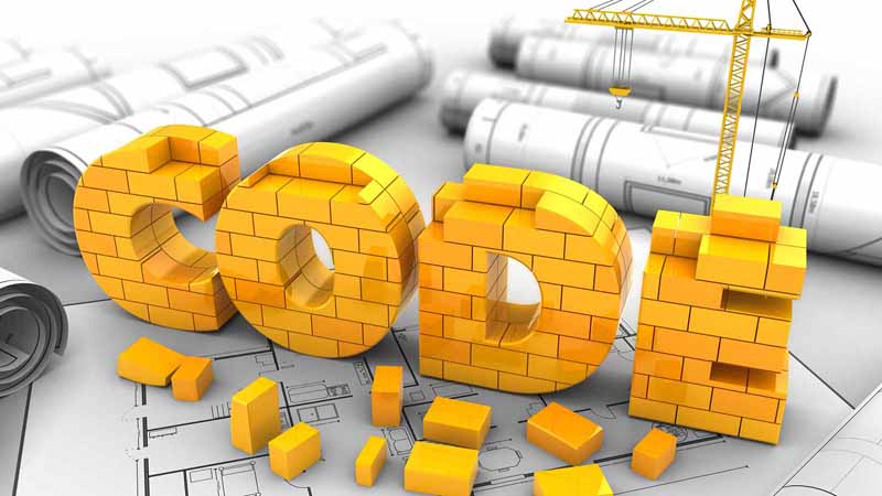 3D crane illustration building CODE out of bricks.