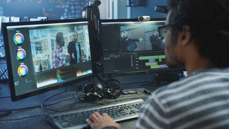 A video editor working at a computer.