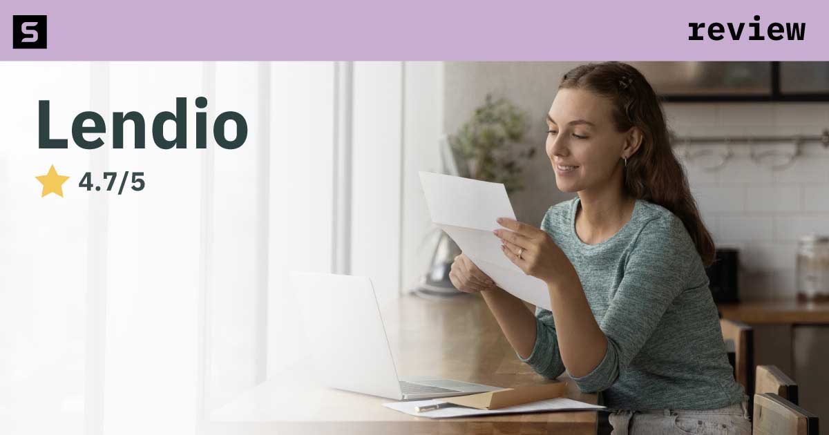 Woman smiling, holding a notebook with text Lendio Review.