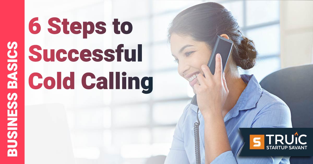 Woman at computer, talking on phone.