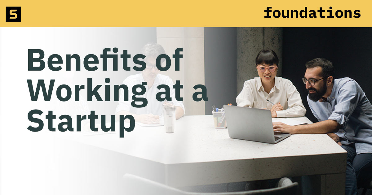 Entrepreneurs laughing at a startup office.